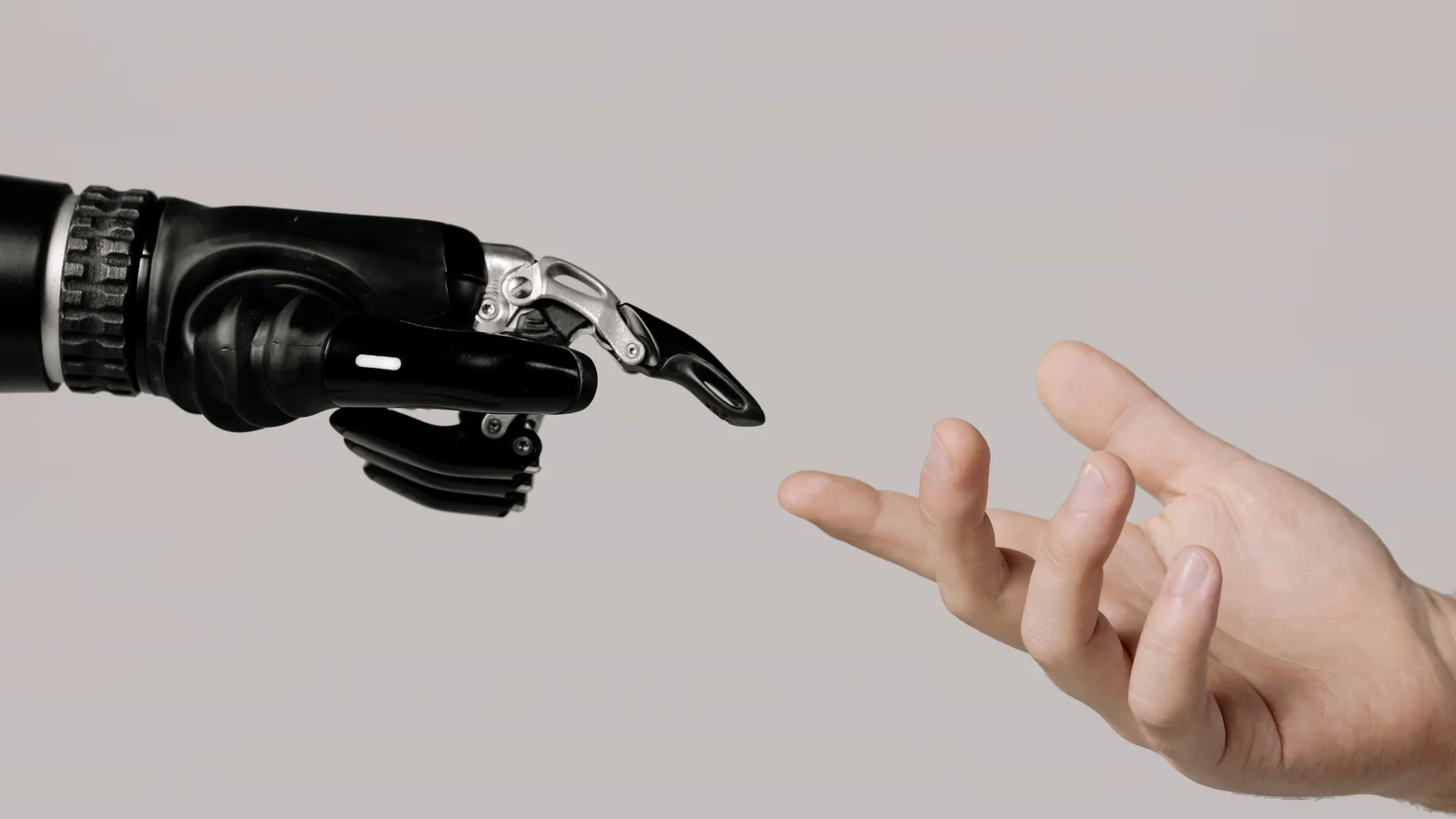 A robotic hand reaching toward a human hand